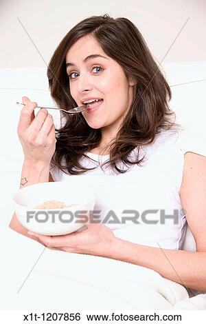 Stock Photograph - Woman eating.. Fotosearch