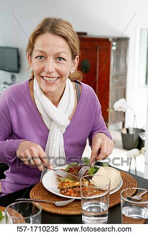 Stock Photography - Woman eating. Fotosearch