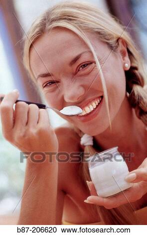 Woman eating yoghurt View Large Photo Image Stock Image - Woman eating yoghurt. Fotosearch