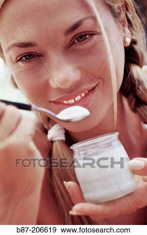 Woman eating yoghurt View Large Photo Image Stock Photo - Woman eating yoghurt. Fotosearch