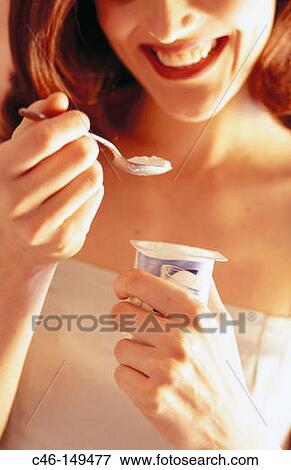 Woman eating yoghurt View Large Photo Image Stock Photo - Woman eating yoghurt. Fotosearch