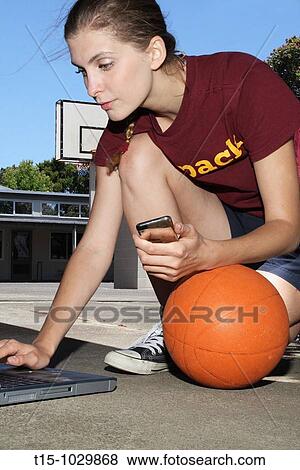 woman email with iphone in a basketball court View Large Photo Image Stock Photo - woman email with iphone in a basketball court. Fotosearch