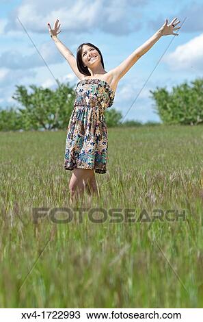Woman enjoy at ruralscape with her Arms Raised View Large Photo Image Stock Image - Woman enjoy at ruralscape with her Arms Raised. Fotosearch