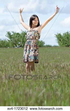 Woman enjoy at ruralscape with her Arms Raised View Large Photo Image Stock Image - Woman enjoy at ruralscape with her Arms Raised. Fotosearch