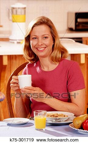 Stock Photo - woman enjoying a cup of coffee. Fotosearch
