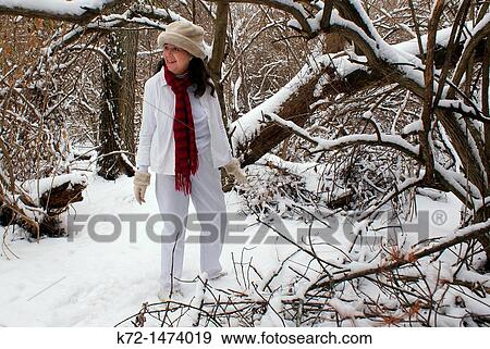 Woman enjoying being in the snow View Large Photo Image Stock Photo - Woman enjoying being in the snow. Fotosearch