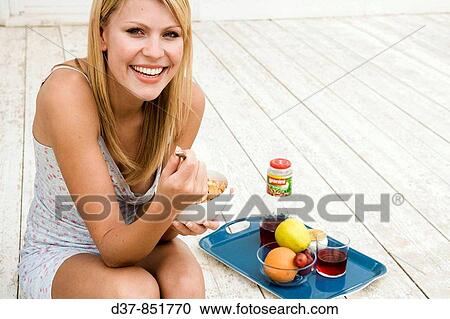 Woman enjoying having breackfast View Large Photo Image Stock Image - Woman enjoying having breackfast. Fotosearch