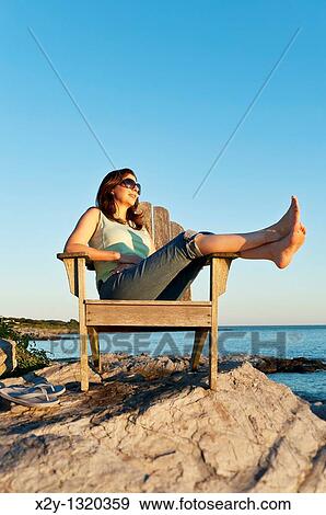 Stock Photo - Woman enjoys the coastal view, Newport, Rhode Island. Fotosearch