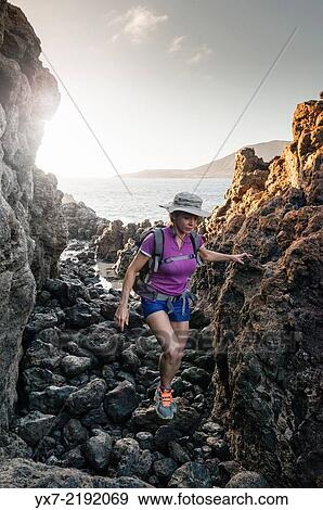 Stock Photo - Woman exploring La Graciosa Island, Lanzarote, Canary Islands, Spain, Europe.. Fotosearch