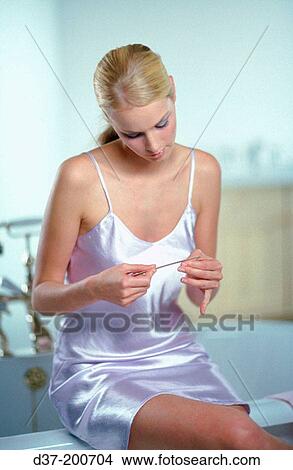 Woman filing her nails View Large Photo Image Picture - Woman filing her nails. Fotosearch