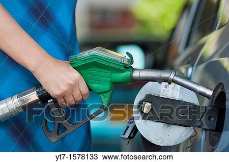 Woman filling up a car with petrol UK View Large Photo Image Stock Image - Woman filling up a car with petrol UK. Fotosearch