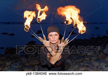 Woman Fire Dancer in Costume Juggling Torches View Large Photo Image Stock Photograph - Woman Fire Dancer in Costume Juggling Torches. Fotosearch