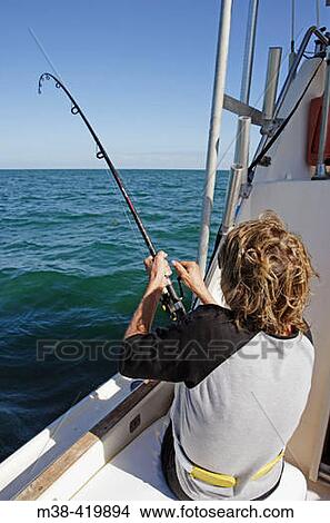 Woman fishing from a boat in Marathon, Florida. USA. December 2004. View Large Photo Image Picture - Woman fishing from a boat in Marathon, Florida. USA. December 2004.. Fotosearch