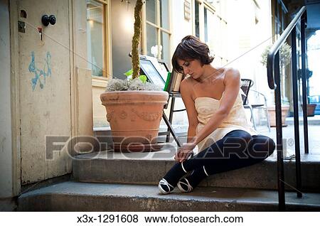 Woman fixing shoes in the streets of Paris France View Large Photo Image Stock Photo - Woman fixing shoes in the streets of Paris France. Fotosearch