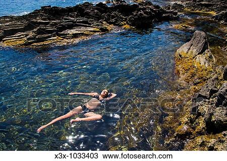 Woman floating in the Mediterranean water Island of Pantelleria, Sicily, Italy View Large Photo Image Stock Image - Woman floating in the Mediterranean water Island of Pantelleria, Sicily, Italy. Fotosearch