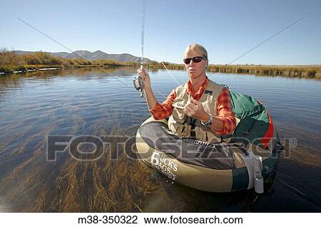 Woman flyfishing on a float tube on Silver Creek, Idaho. USA View Large Photo Image Stock Image - Woman flyfishing on a float tube on Silver Creek, Idaho. USA. Fotosearch