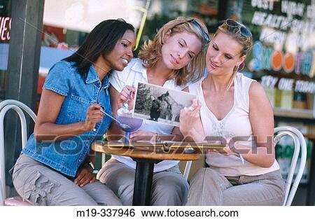 woman friends looking at a photo View Large Photo Image Stock Photograph - woman friends looking at a photo. Fotosearch