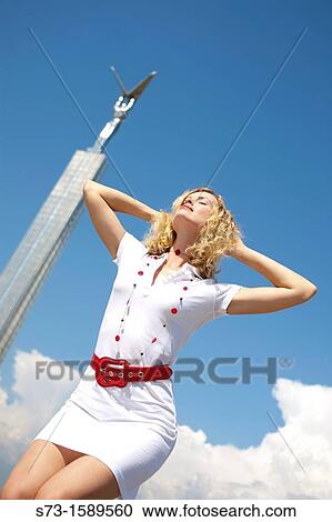 Stock Image - Woman front the Glory Monument in Samara, Samara Region, Russian Federation, Russia. Fotosearch