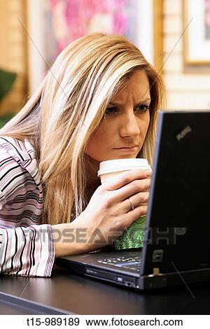 Woman frustrated staring at her laptop View Large Photo Image Stock Photo - Woman frustrated staring at her laptop. Fotosearch