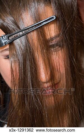 Woman getting hair done, close-up with hair over face View Large Photo Image Stock Image - Woman getting hair done, close-up with hair over face. Fotosearch