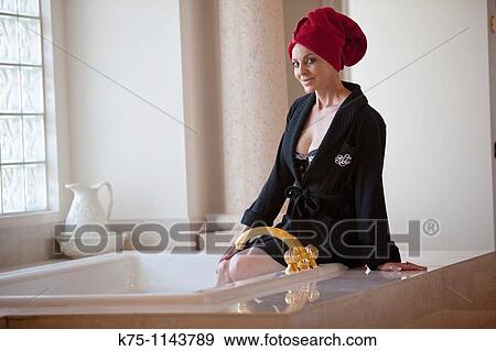 Woman getting her bath ready View Large Photo Image Stock Photo - Woman getting her bath ready. Fotosearch