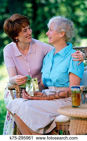 woman giving her senior mom a present View Large Photo Image Stock Image - woman giving her senior mom a present. Fotosearch