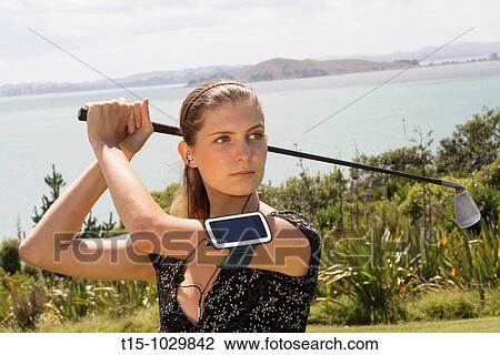 woman golfing listening to music View Large Photo Image Stock Image - woman golfing listening to music. Fotosearch