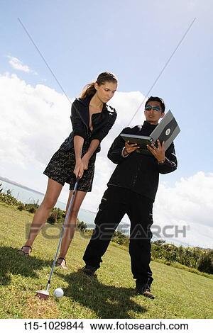 woman golfing look at a laptop View Large Photo Image Picture - woman golfing look at a laptop. Fotosearch