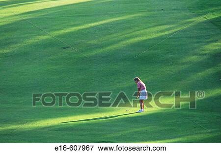 Woman golfing View Large Photo Image Stock Photo - Woman golfing. Fotosearch