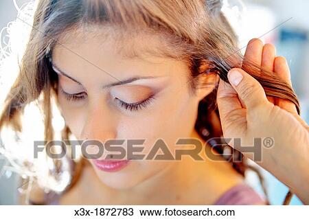 Stock Image - Woman hair styling. Fotosearch