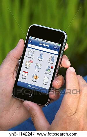 Woman hand holding an iPhone showing Facebook screen View Large Photo Image Stock Photo - Woman hand holding an iPhone showing Facebook screen. Fotosearch