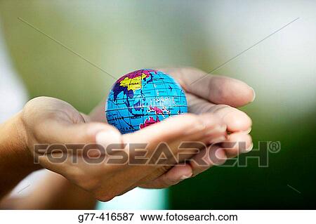Woman hands holding small world globe View Large Photo Image Stock Photo - Woman hands holding small world globe. Fotosearch