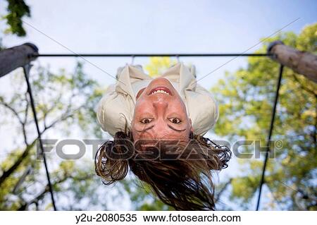Stock Photography - Woman hanging upside down in ticino switzerland.. Fotosearch
