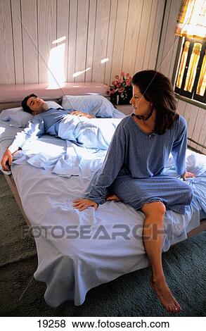 Woman happy, man sleeps View Large Photo Image Stock Photo - Woman happy, man sleeps. Fotosearch
