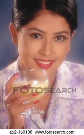 Woman having a drink View Large Photo Image Stock Photo - Woman having a drink. Fotosearch