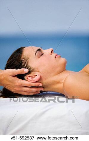 Woman having a massage by the sea View Large Photo Image Stock Photo - Woman having a massage by the sea. Fotosearch