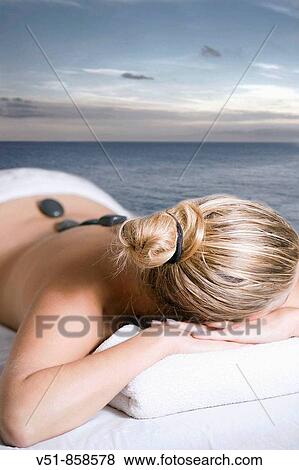 Woman having a massage by the sea View Large Photo Image Stock Photo - Woman having a massage by the sea. Fotosearch
