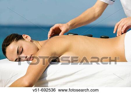 Woman having a massage by the sea View Large Photo Image Stock Photograph - Woman having a massage by the sea. Fotosearch