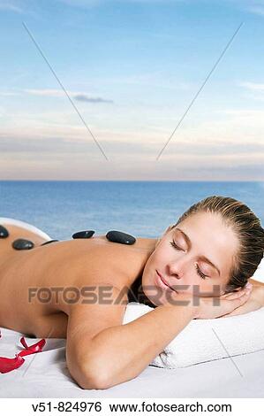 Woman having a massage by the sea View Large Photo Image Stock Photograph - Woman having a massage by the sea. Fotosearch