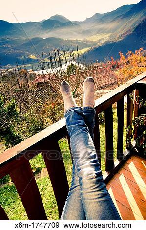 Stock Photo - Woman having a rest in a holiday cottage Campiellos Sobrescobio Redes National Park, Asturias, Spain. Fotosearch