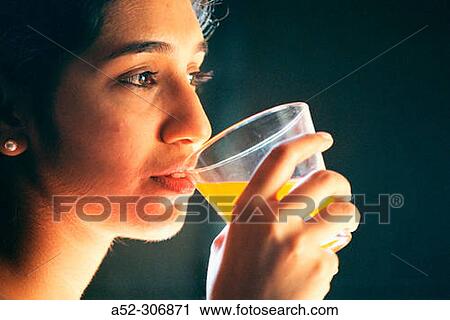 Woman having an orange juice View Large Photo Image Stock Image - Woman having an orange juice. Fotosearch