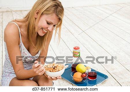 Woman having breackfast at home View Large Photo Image Stock Image - Woman having breackfast at home. Fotosearch