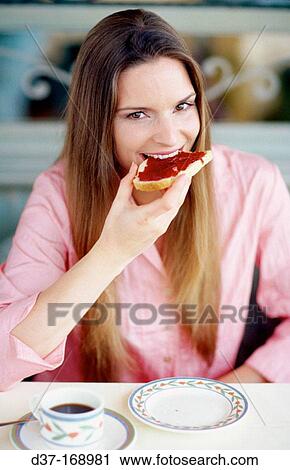 Stock Image - Woman having breakfast. Fotosearch