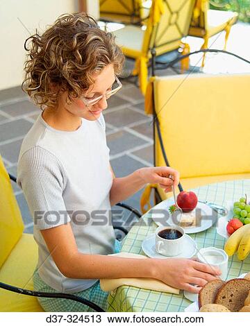 Woman having breakfast View Large Photo Image Stock Image - Woman having breakfast. Fotosearch