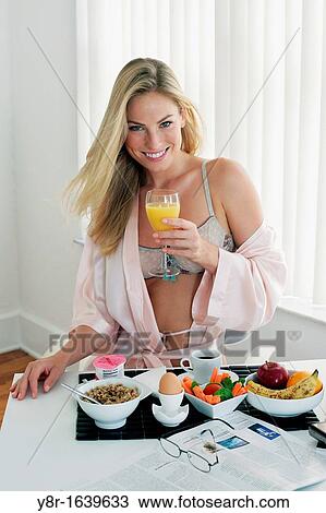 Stock Image - Woman having breakfast. Fotosearch