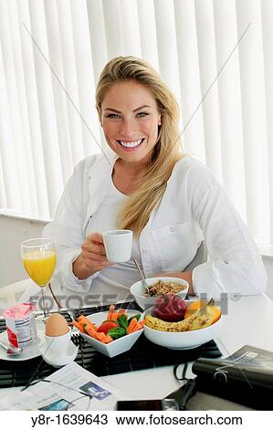 Woman having breakfast View Large Photo Image Stock Image - Woman having breakfast. Fotosearch