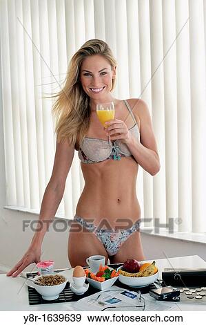 Stock Photo - Woman having breakfast. Fotosearch