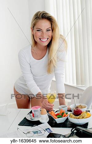 Stock Photography - Woman having breakfast. Fotosearch