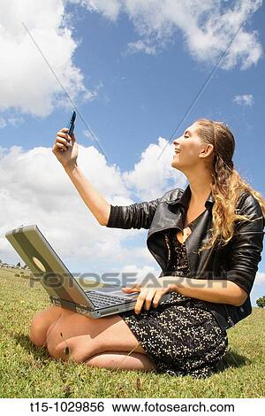 woman having fun with cell phone and laptop View Large Photo Image Stock Photograph - woman having fun with cell phone and laptop. Fotosearch