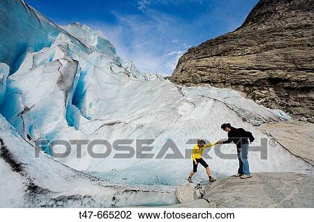 Woman helping another one in Jostedalsbreen glacier (Nigardsbreen). Sogn og Fjordane. Norway. View Large Photo Image Stock Image - Woman helping another one in Jostedalsbreen glacier (Nigardsbreen). Sogn og Fjordane. Norway.. Fotosearch